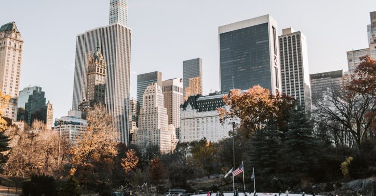 People Ice Skating in the Park Near High Rise Buildings