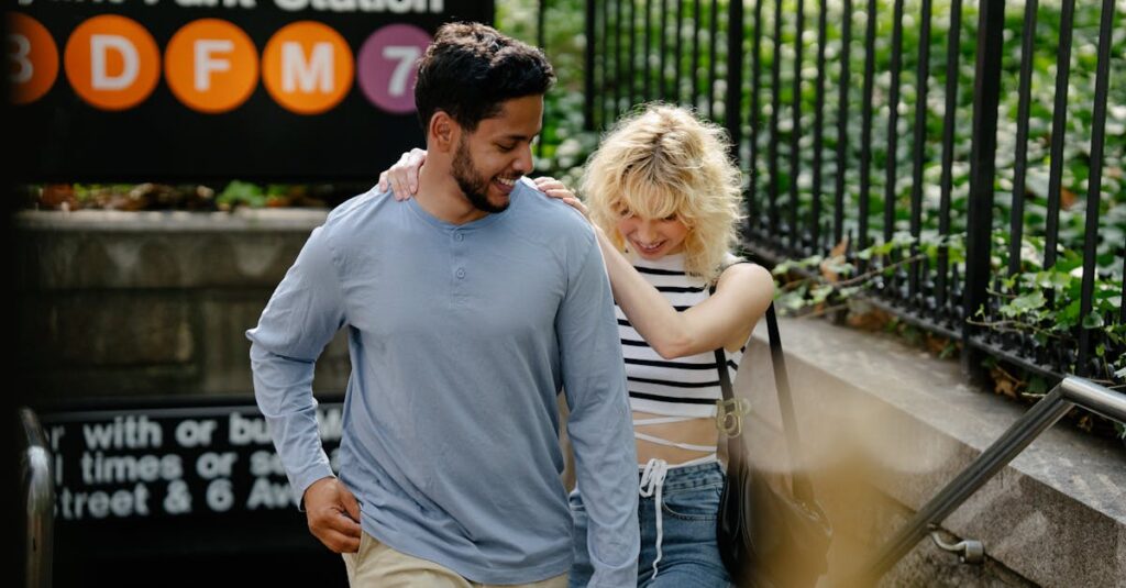 Smiling couple exiting Bryant Park metro station in New York City on a sunny day.