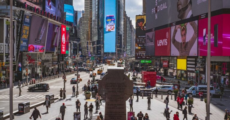Bustling Times Square, NYC, captures urban life with crowds, traffic and billboards.