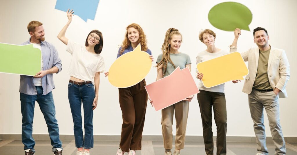 Diverse group of smiling adults holding vibrant speech bubbles indoors.