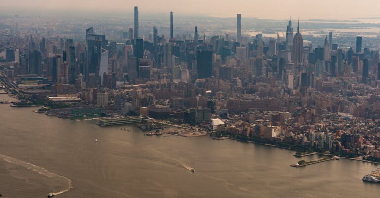A stunning aerial view of New York City's iconic skyline and river.