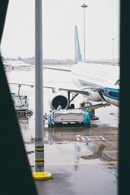 JetBlack Freight 11 Workers in protective gear load cargo onto an airplane at Shanghai airport.