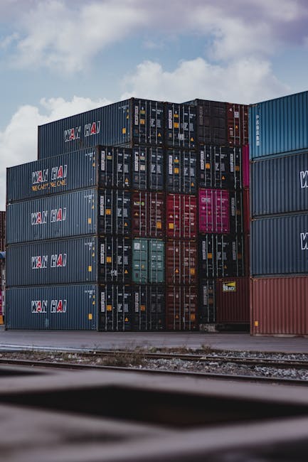 JetBlack Freight 10 High vertical stack of cargo containers at a port, symbolizing global logistics.