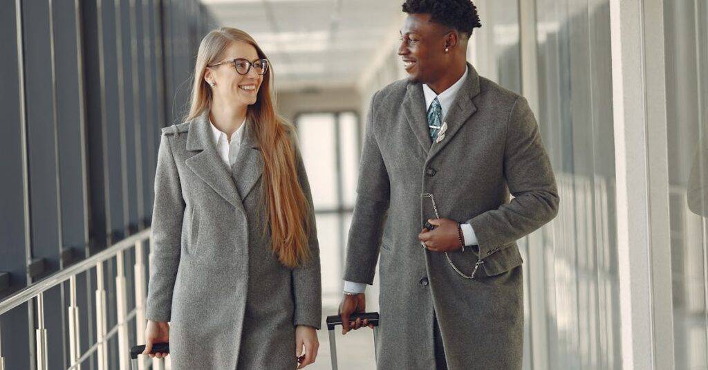 Couple walking with rolling luggage through an airport jet bridge