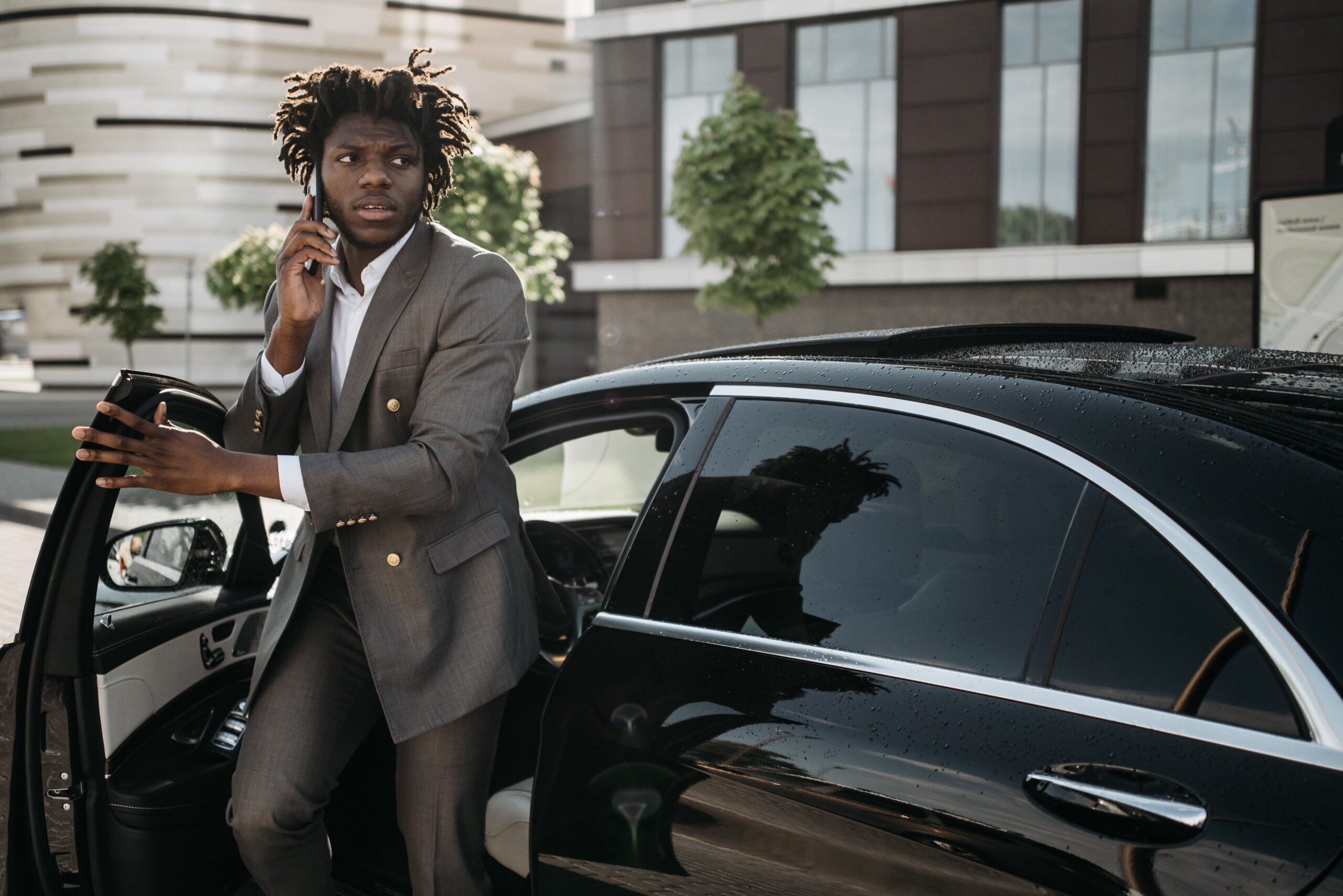 happy traveler greeting a chauffeur at an airport arrivals curb — Manhattan to Newark Airport car service