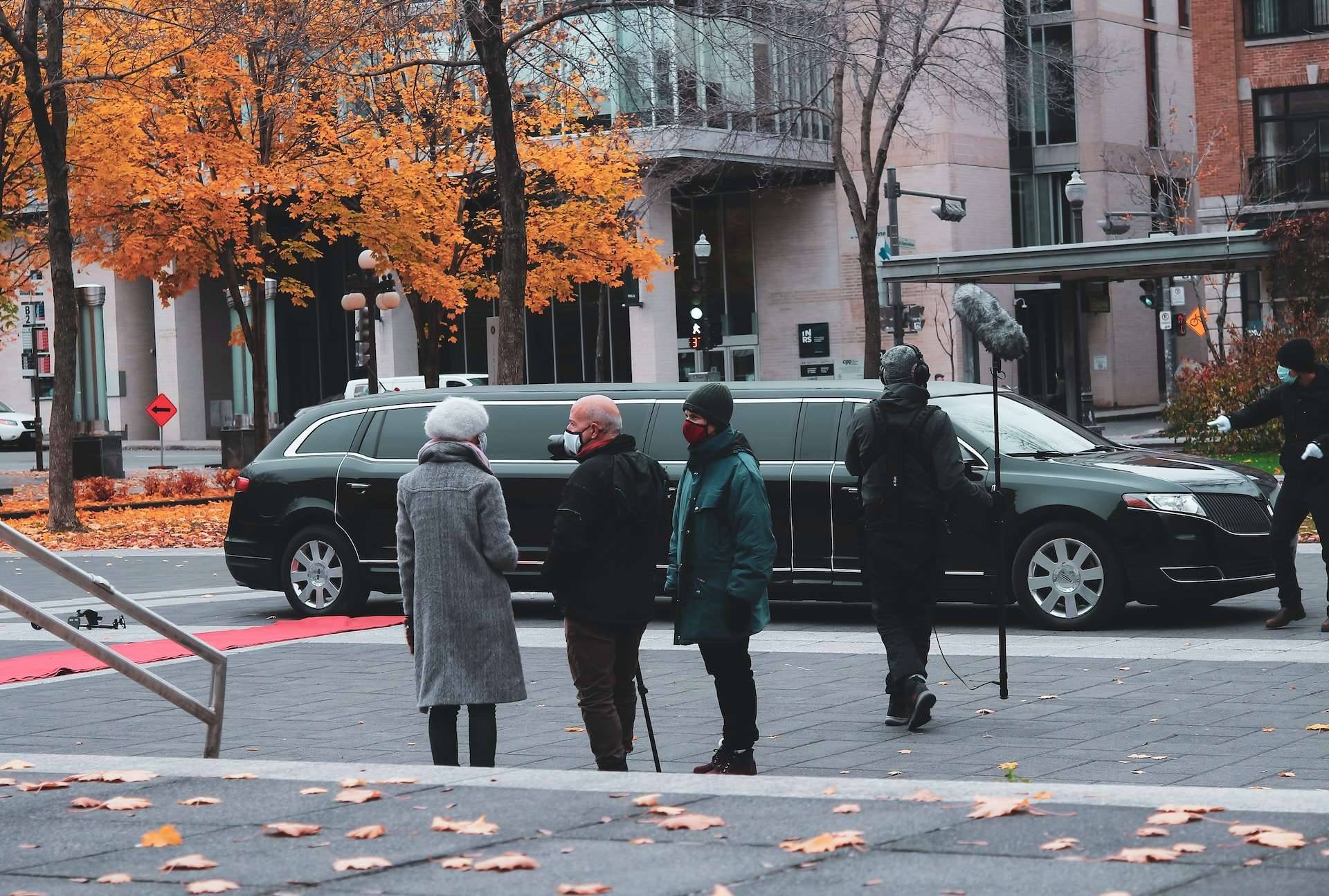 Black stretch limousine on a city street in autumn
